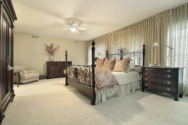 Master bedroom with dark wood furniture — Stock Photo #8679488