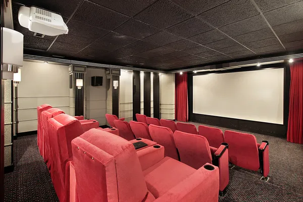 Home theater with red chairs