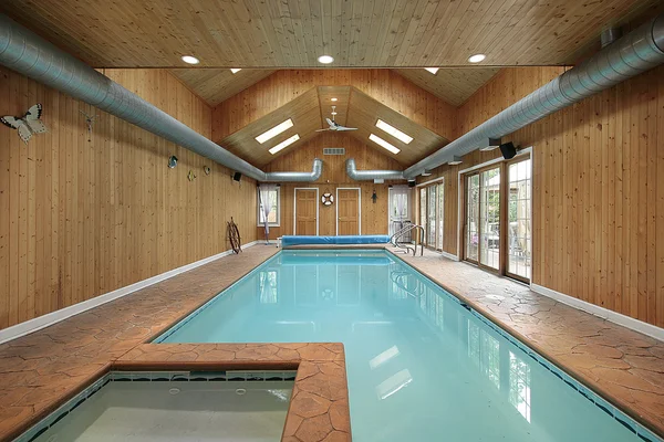 Indoor swimming pool with wood siding