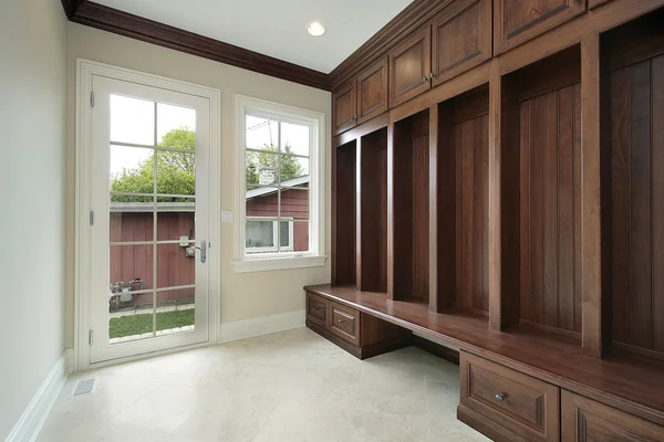 Mud room with wood cabinet