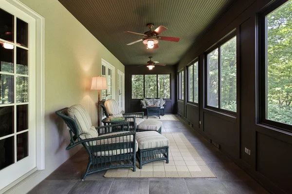 Porch with dark wood paneling