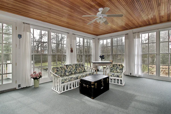 Porch in suburbs with wood paneled ceiling