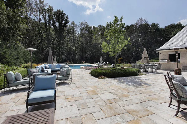 Large stone patio with swimming pool