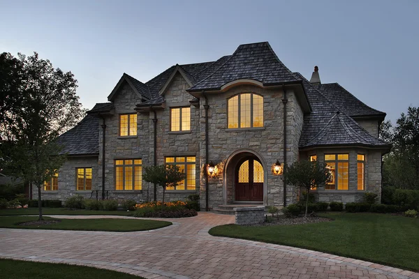 Luxury stone home at dusk