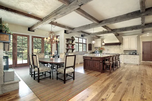 Kitchen with island and ceiling wood beams