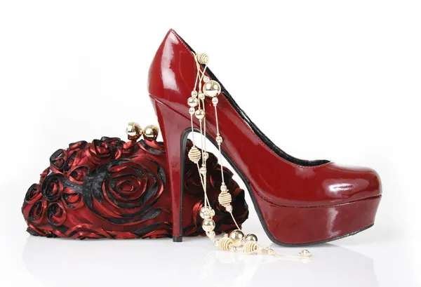 Red shoe, clutch bag and gold necklace