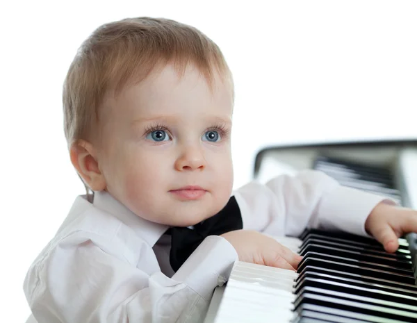 Adorable child playing electronic piano