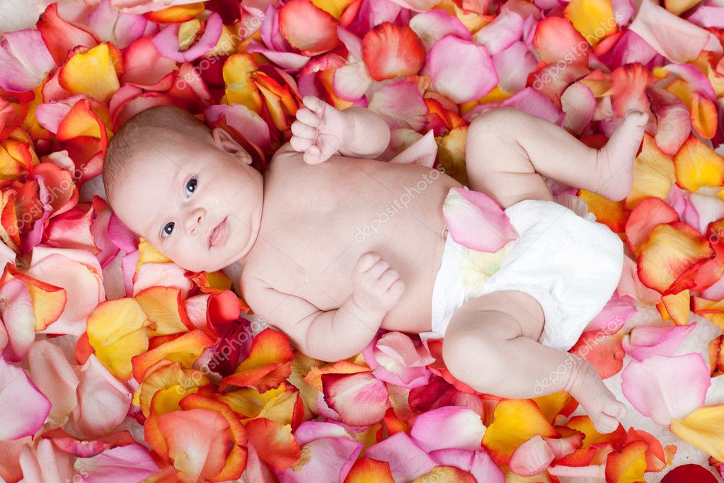 Happy Newborn Baby Lying Among Rose Petals — Stock Photo © Oksun70 #9658548