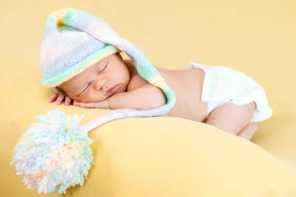 Adorable baby girl weared cap sleeping on her stomach