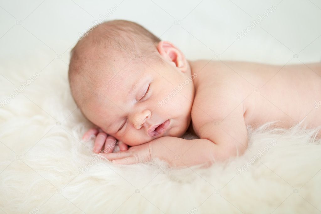 newborn-baby-girl-sleeping-on-her-stomach-stock-photo-oksun70-9777336