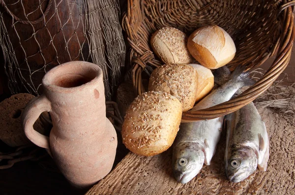 Wine jug with bread and fish