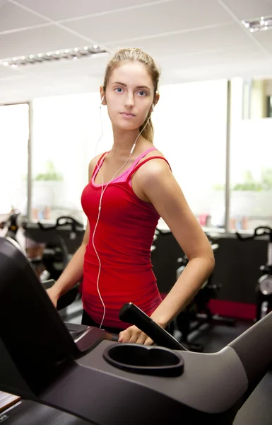 Young woman at gym on treadmill