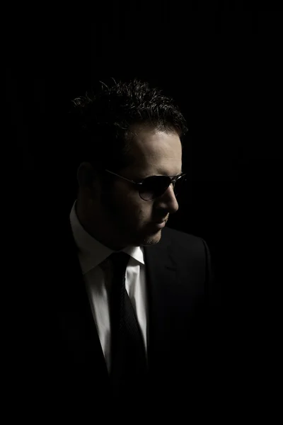 Man in suit and Sunglasses over Black