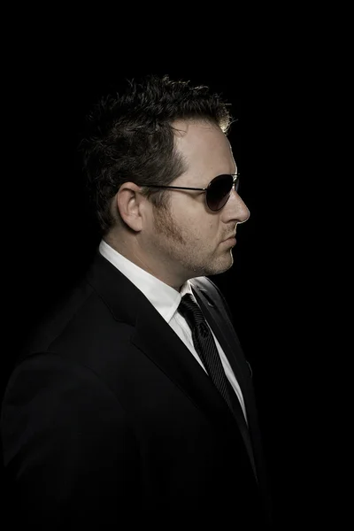 Profile of White Man in Suit and Sunglasses