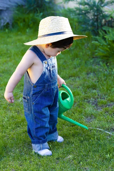 Little baby gardener lost in his task at hand