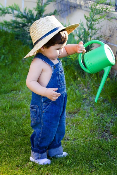 Little baby gardener testing his tools