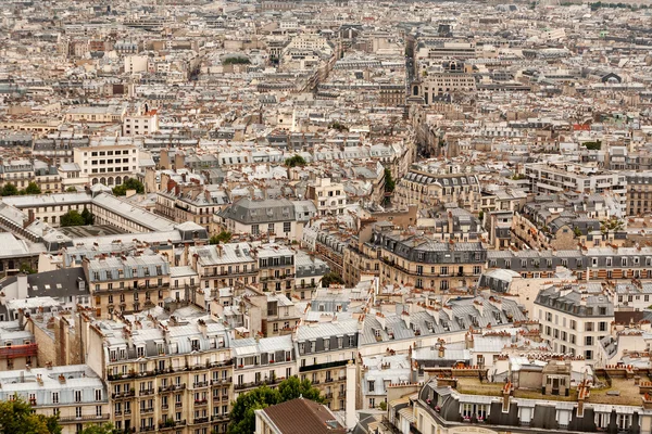 A vast sea of rooftops across a Paris cityscape