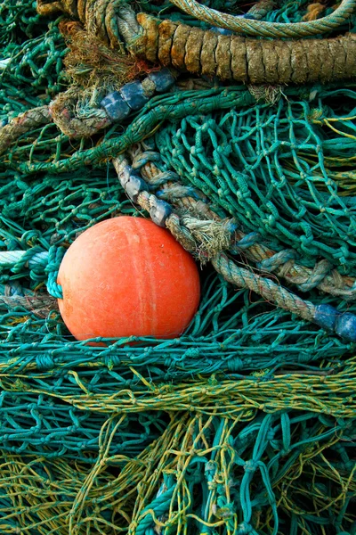 Green fishing netting with red buoy
