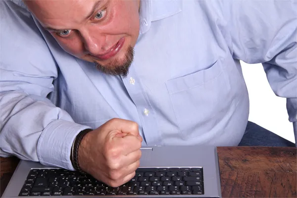 Angry man in front of computer