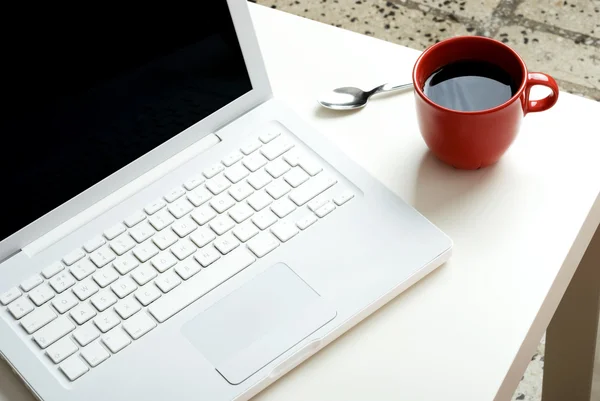 White laptop and coffee
