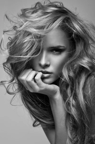 Black and white vogue style portrait of delicate blonde woman