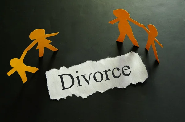 Torn piece of paper with divorce text and paper family figures