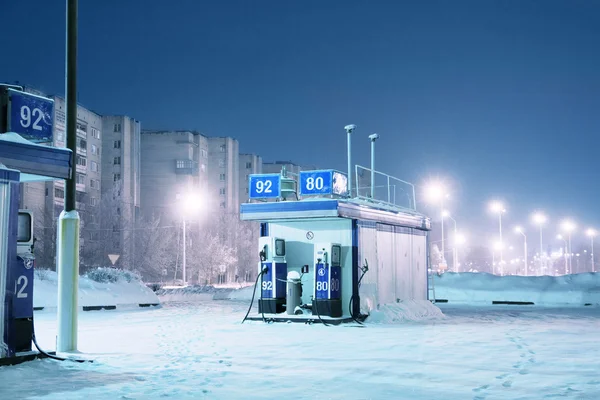 Gas station at night city lights of winter
