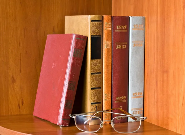 Books and glasses on bookshelf