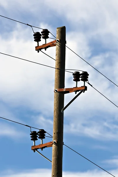 Electric pole against a blue sky.