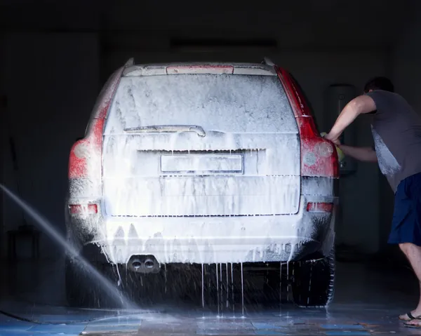 The man washes the car