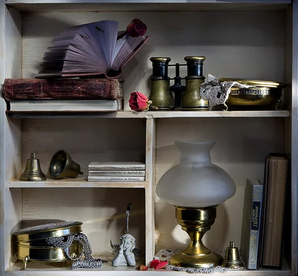 Shelf with books and binoculars