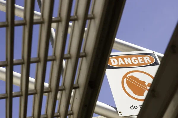 Danger sign viewed from under stairs