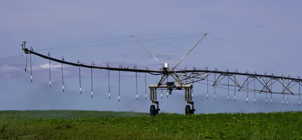 Pivot irrigation system in operation supplying water