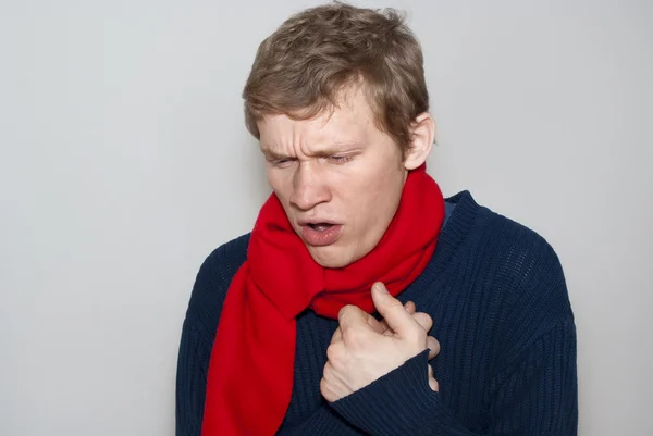 Guy on a gray background coughing