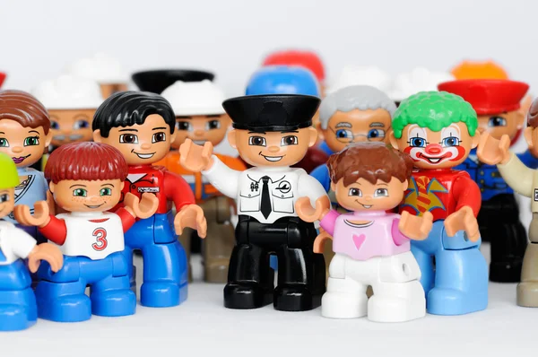 A group of Lego brand Duplo Figures with happy faces