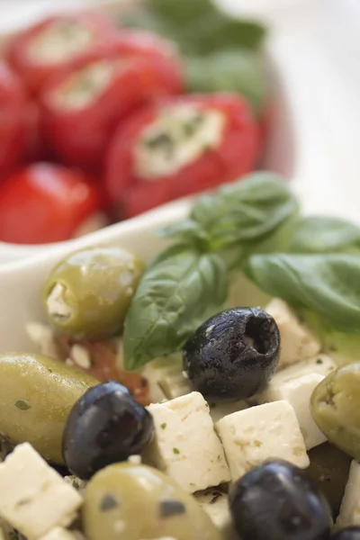 Salad of black, green olives with pieces of cheese.