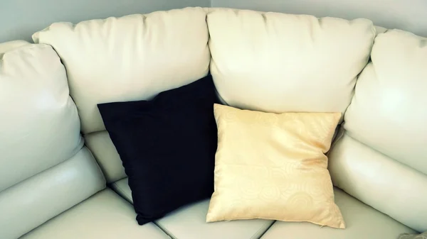 Two pillows black and white on white sofa
