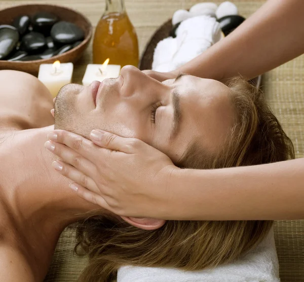 Spa. Young Man getting Face Massage