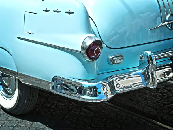 Rear view of a vintage car fin closeup. blue