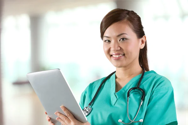 Portrait of a Female doctor holding a digital tablet.
