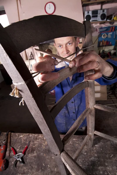 Carpenter repairing chair