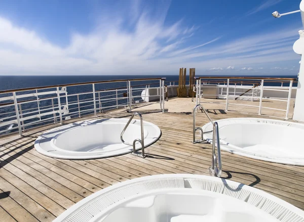 Three hot tub on the deck of a cruise