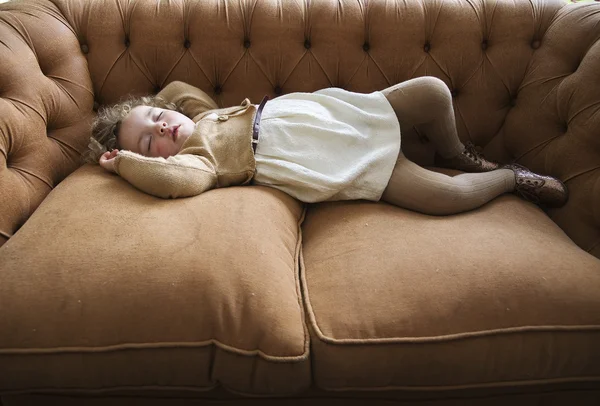 Sleeping girl lying on a couch