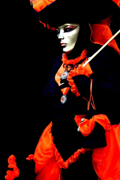 Masked woman on black background,
