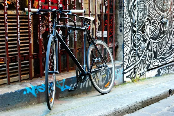 A black bike and urban graffiti in Melbourne