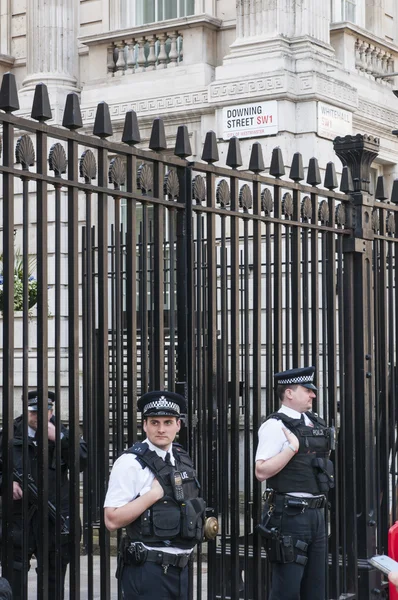 LONDON, UK - APRIL 02: Three policemen manning the gates of Down