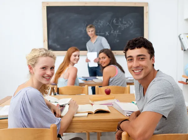 Teenagers studying together in a class