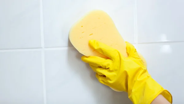 Close-up of a woman cleaning a bathroom