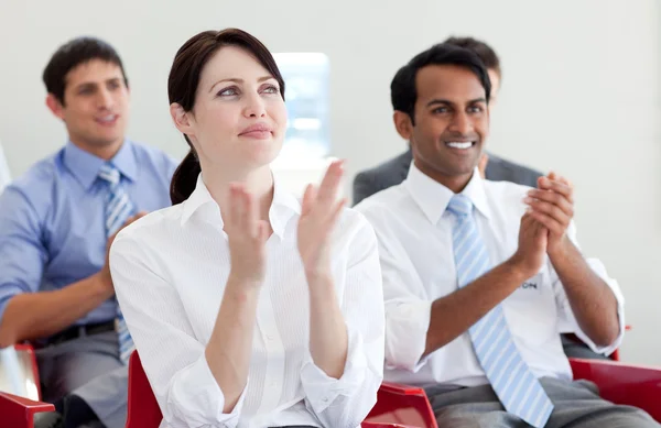International business clapping at a conference