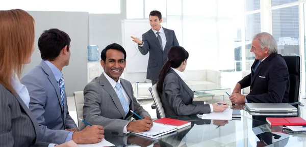 Businessman reporting sales figures to his team